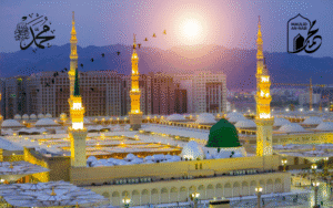 Sunset over the Prophet's Mosque in Medina, featuring its green dome and minarets, with Islamic calligraphy. This image evokes reflection on what to do on Milad Un Nabi.